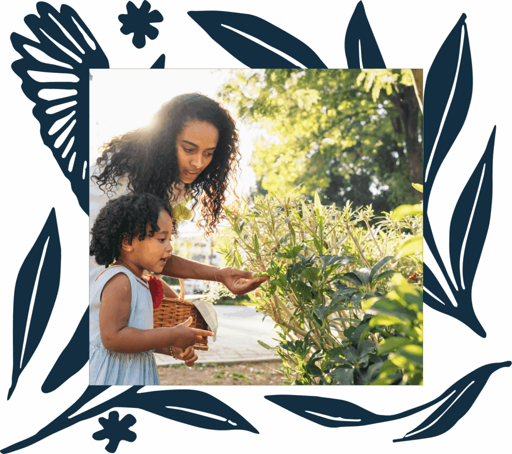 An adult and a child with a basket examine green bushes outdoors on a sunny day near Uplands Westminster, with decorative leaf illustrations framing the photo.